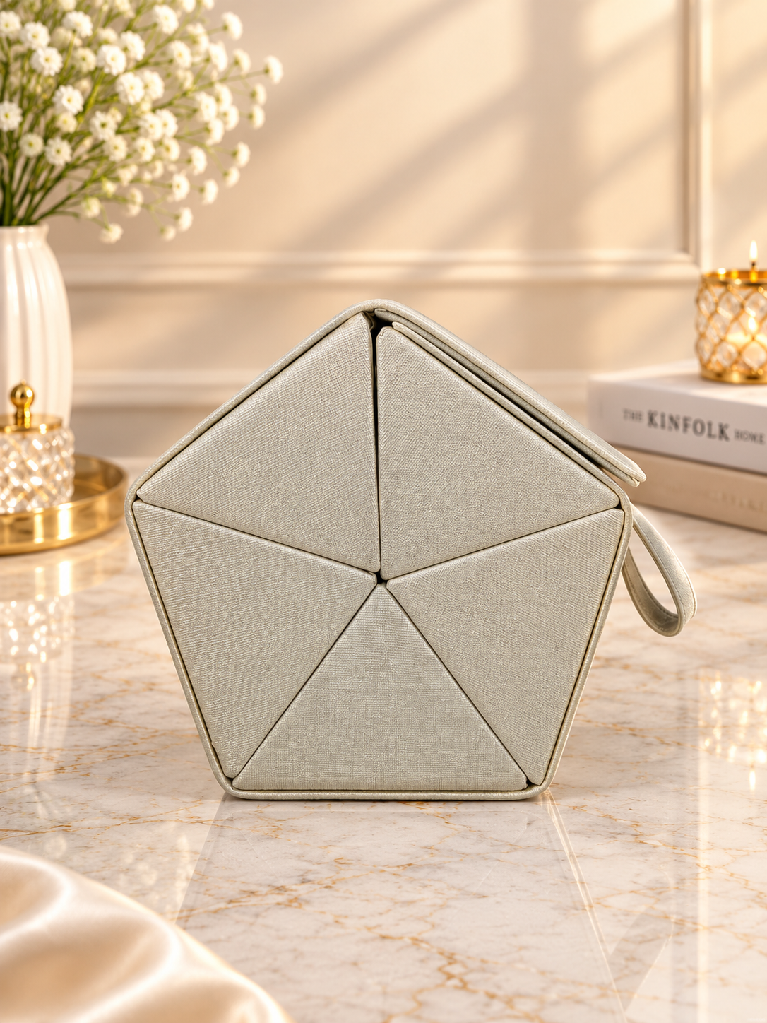 Beige hexagon hanging jewelry organizer case with handle loop and stitched panel design