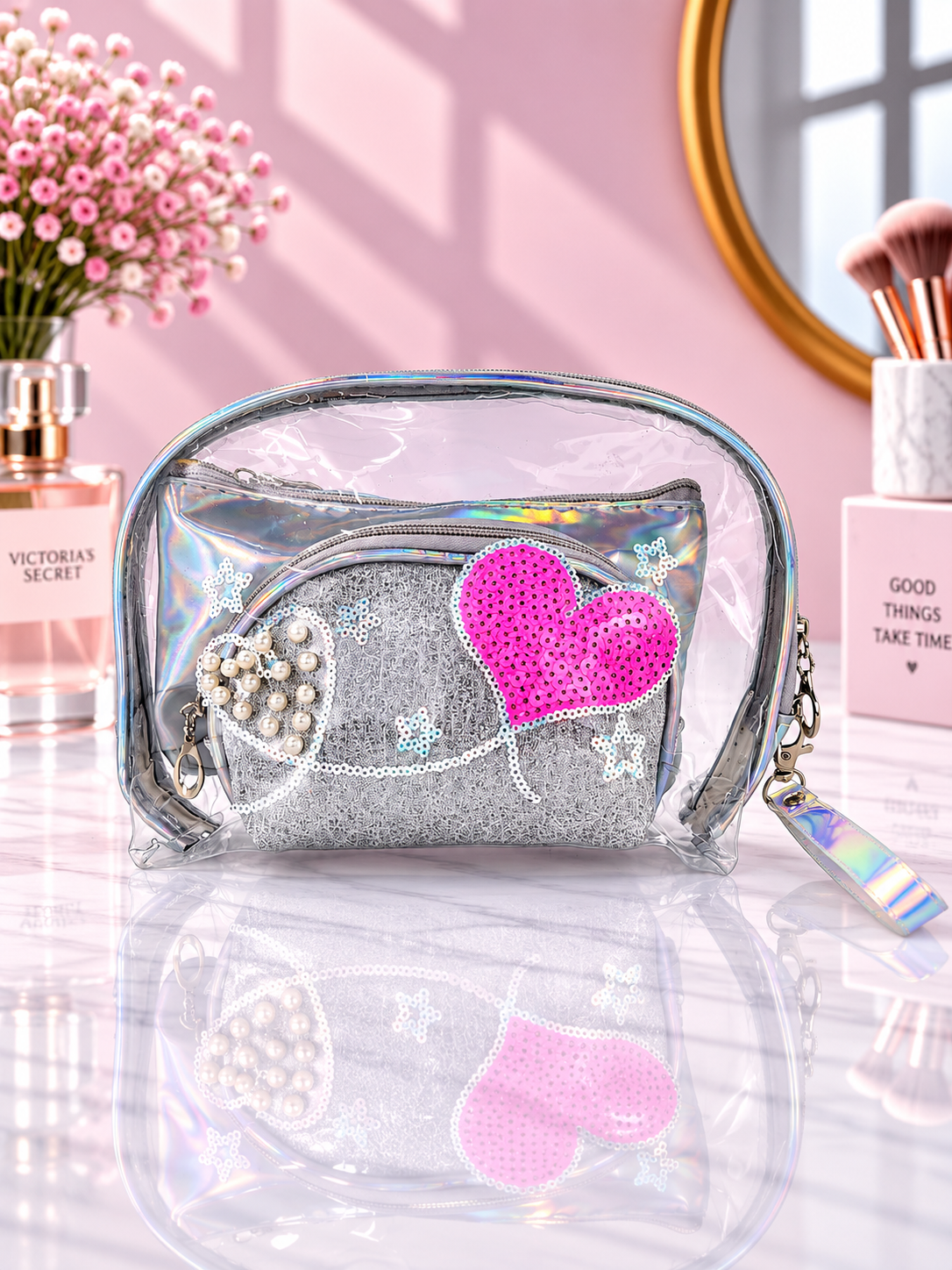 Silver transparent cosmetic organizer pouch with pink sequined heart and bead-like details
