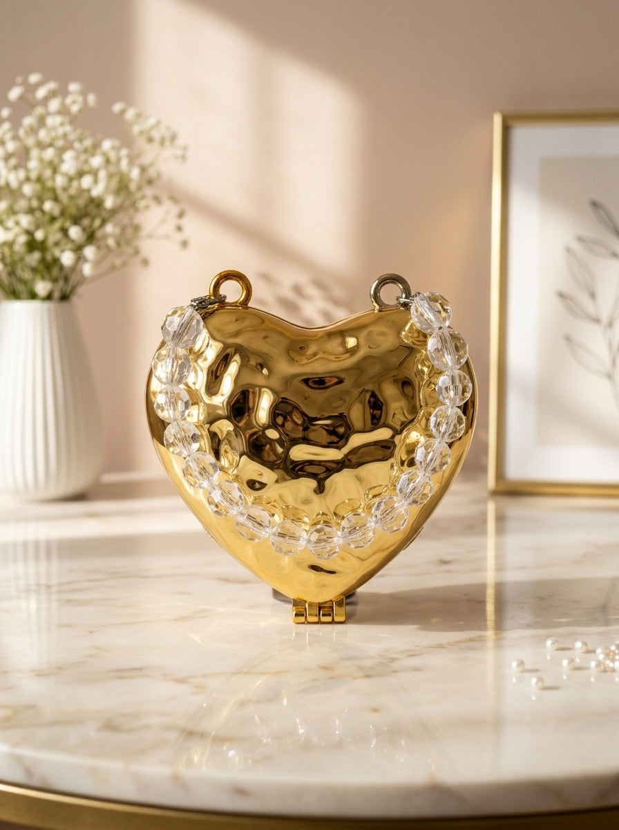 Gold hammered heart evening clutch with crystal side embellishments and chain strap