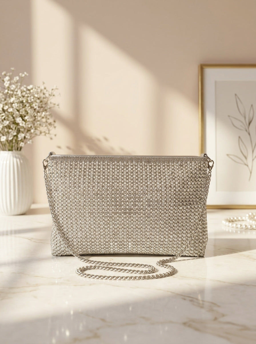 Silver crystal mesh envelope clutch with chain strap, rectangular snap flap.