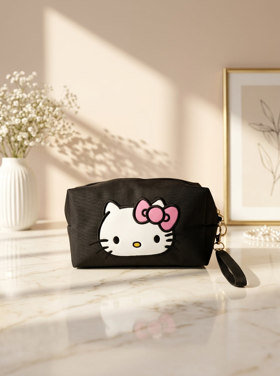 Hello Kitty canvas cosmetic pouch in black, bow-face graphic and wrist strap