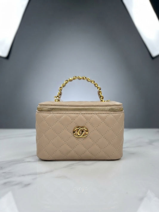 Beige quilted vanity cosmetic case with chain handle, top zip, and interlocking CC logo