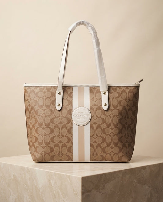 Tan monogram tote bag with center circle logo and vertical red/white stripe