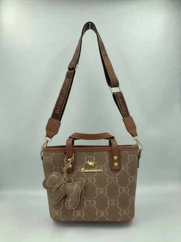 Brown and tan monogram tote bag with shoulder straps and front animal charm