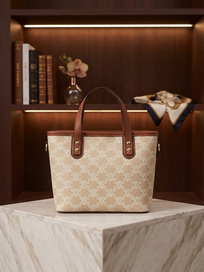 Beige monogram print structured tote bag with tan leather handles and animal charm