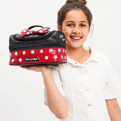 Red Minnie lunch bag with white polka dots, black handle, held by a child