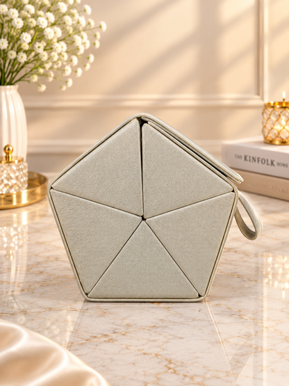 Beige hexagon hanging jewelry organizer case with handle loop and stitched panel design