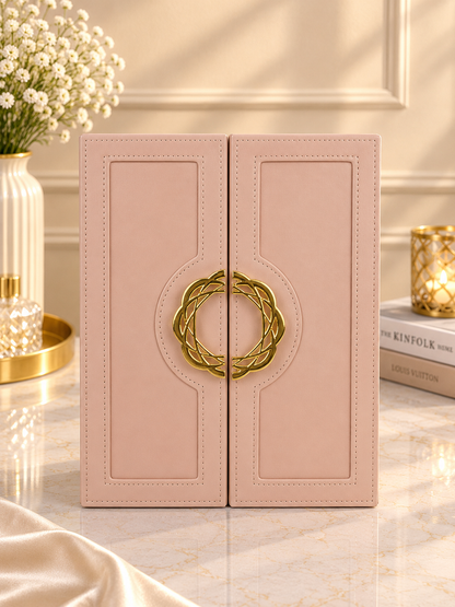 Pink swing-door jewelry box front with gold crest emblem and stitched panels