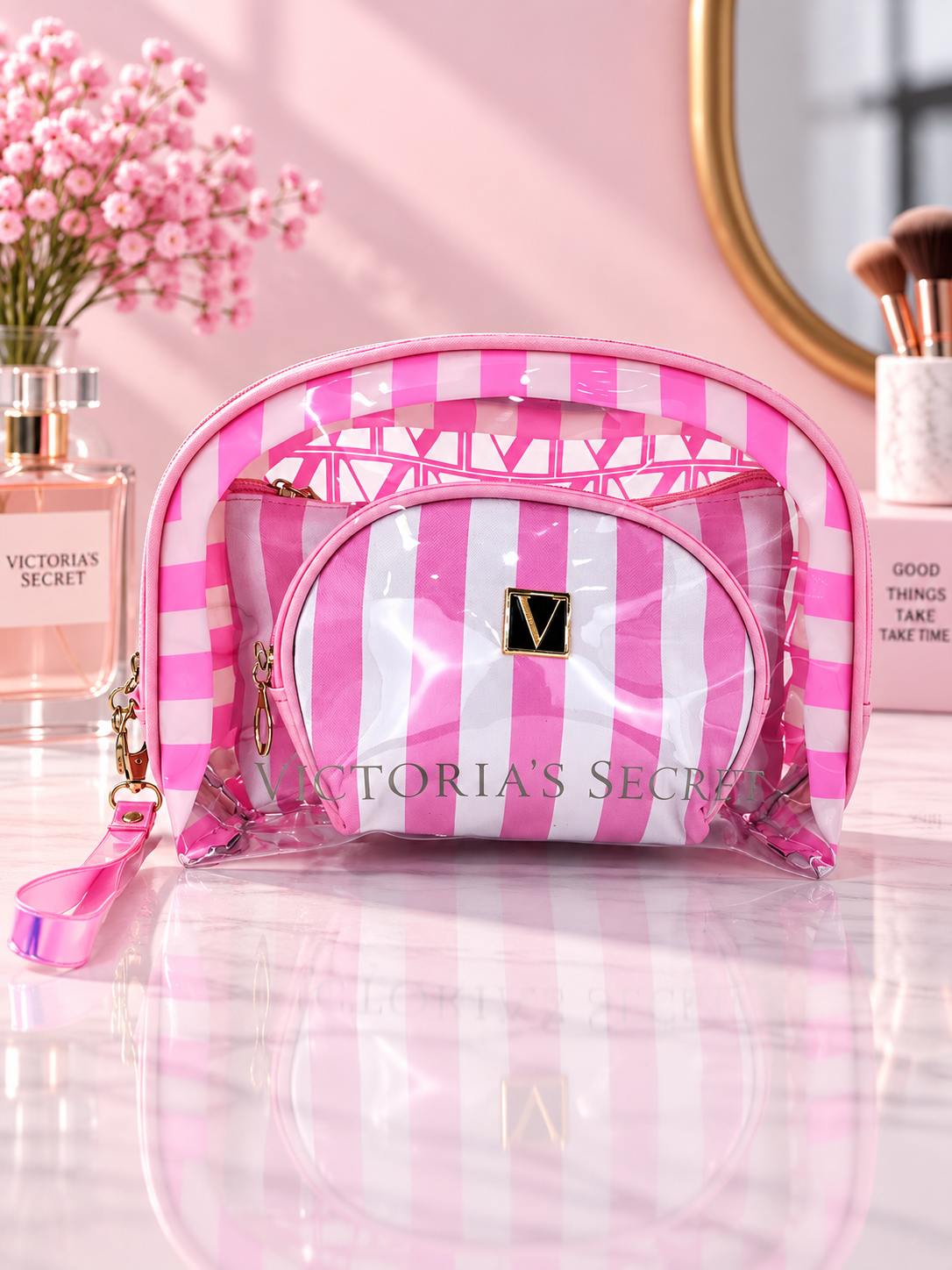 Light pink and white striped cosmetic organizer with clear zip pouches and V logo patch