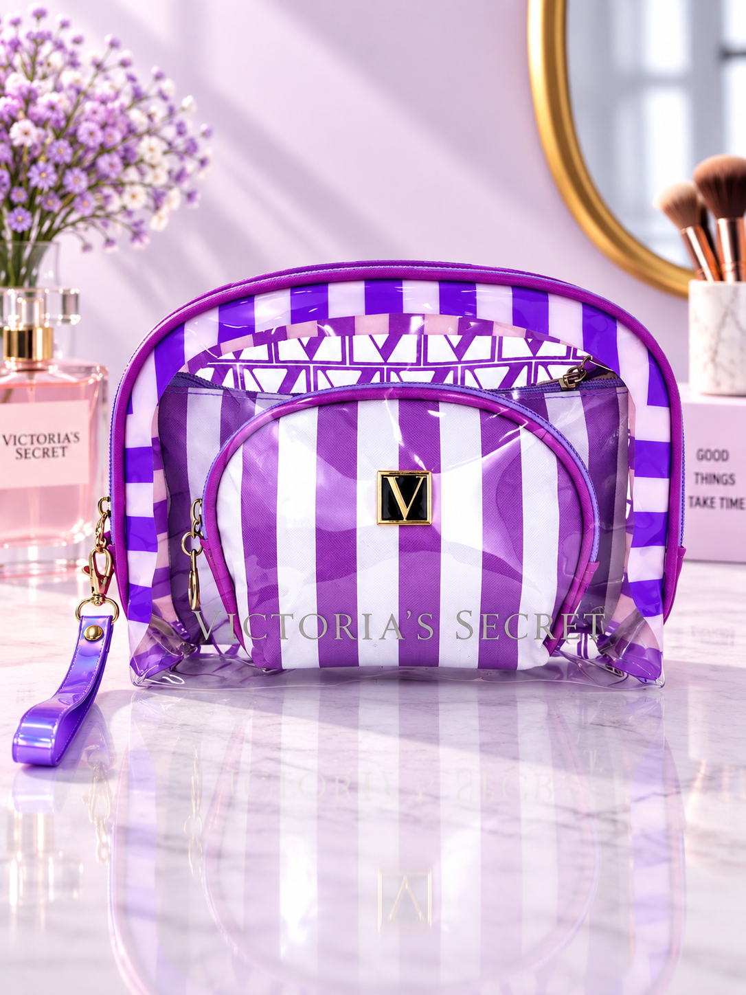 Purple and white striped cosmetic organizer with clear zip pouches and V logo patch