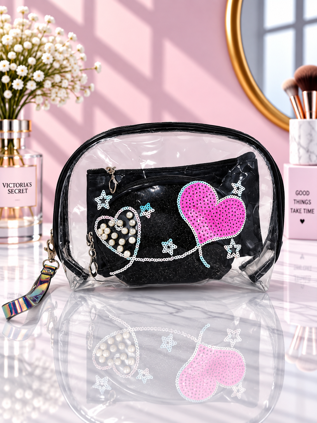 Black transparent cosmetic organizer pouch with pink sequined heart and pearl embellishments