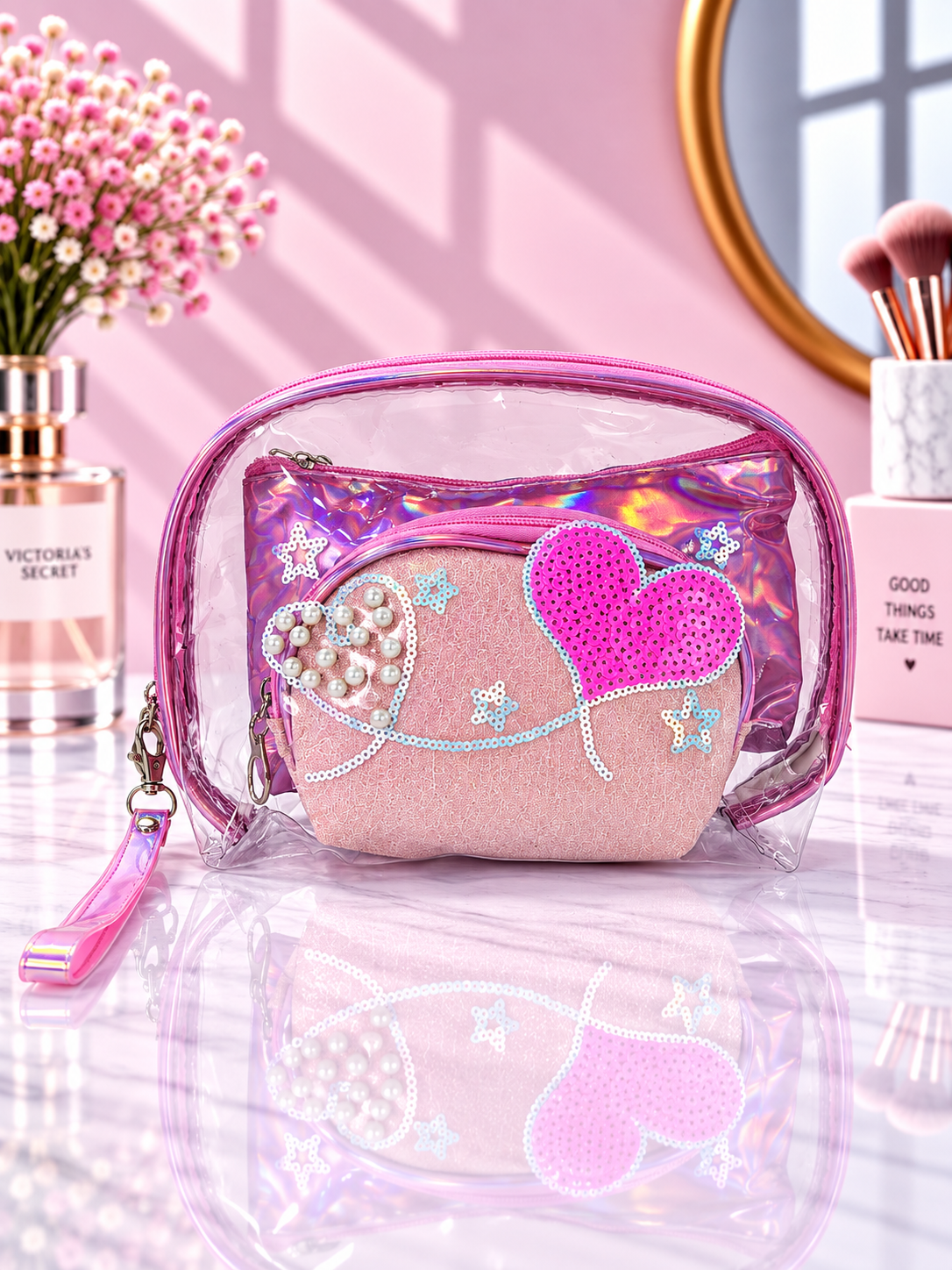 Pink transparent cosmetic organizer pouch with sequined heart and pearl-style details