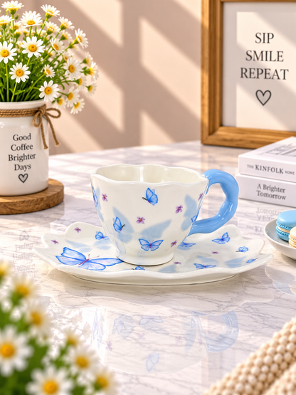 Blue butterfly ceramic coffee cup and saucer set, white base with blue butterfly pattern.
