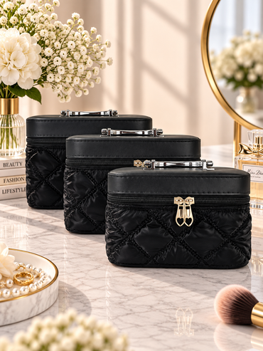 Quilted vanity box set in black with three zippered quilted boxes and metal clasp handles