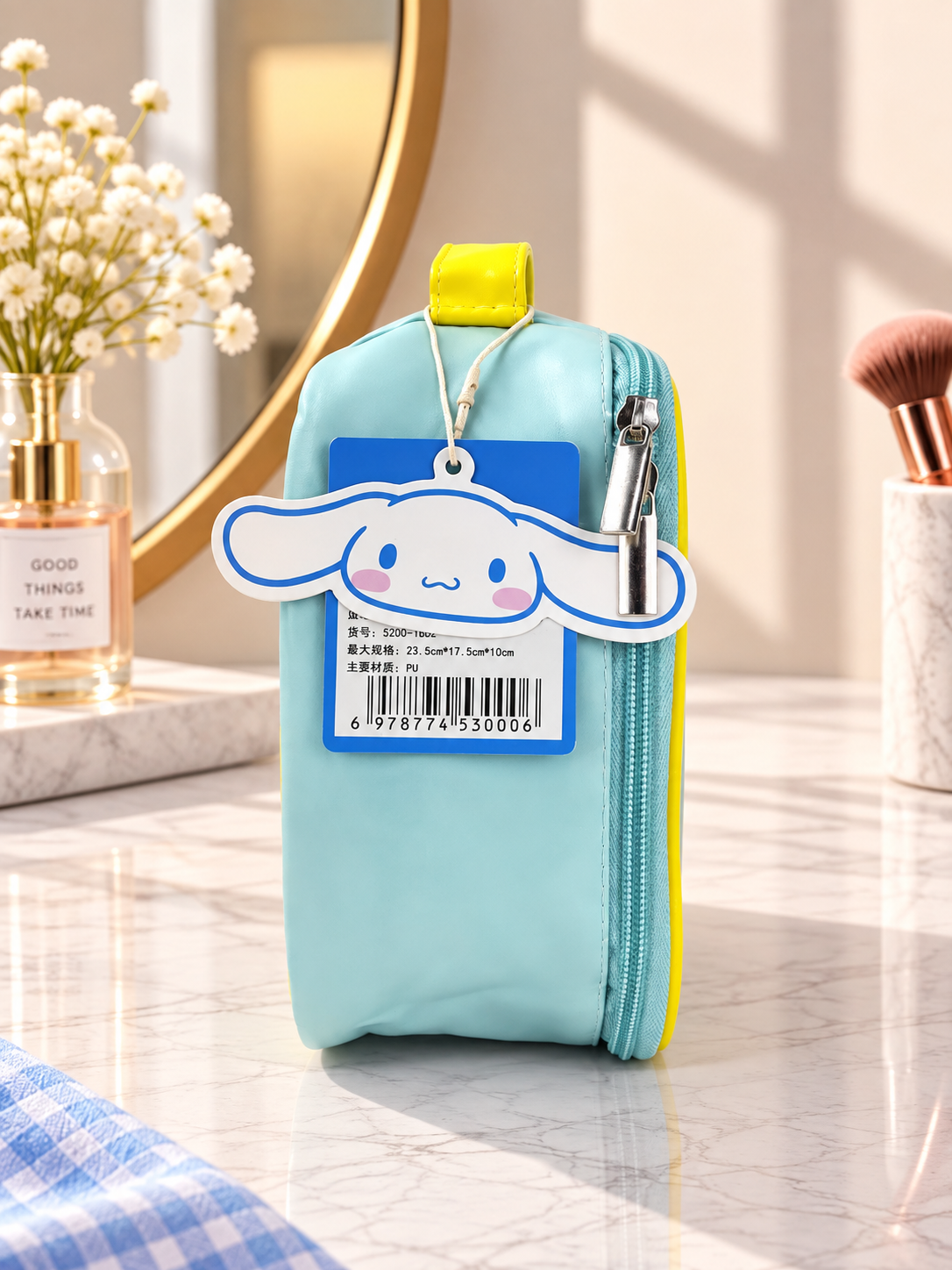 Light blue Cinnamoroll cosmetic bag with yellow trim, zipper top and hanging key tag