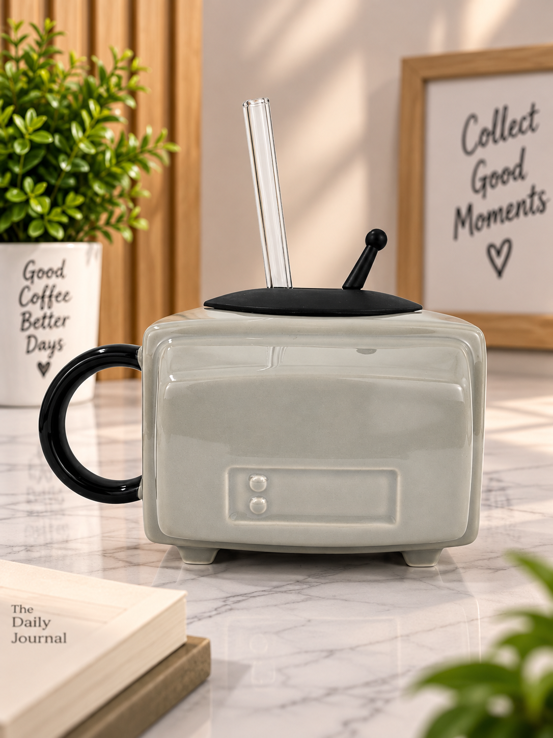 Grey ceramic TV-style mug with black handle, lid, and clear front panel