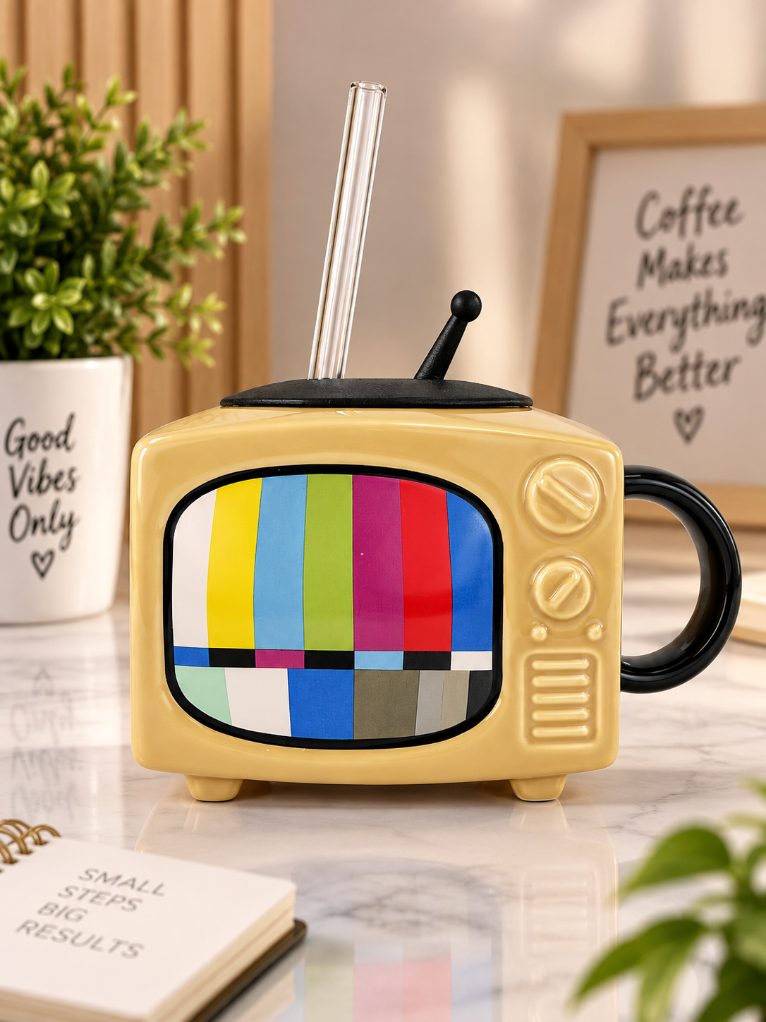 Yellow ceramic TV-style mug with black handle, lid, and colorful screen
