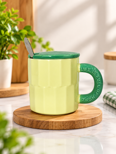 Light green fluted ceramic mug with green lid and spoon.