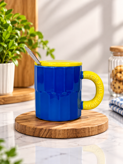 Blue fluted ceramic mug with yellow lid and spoon.