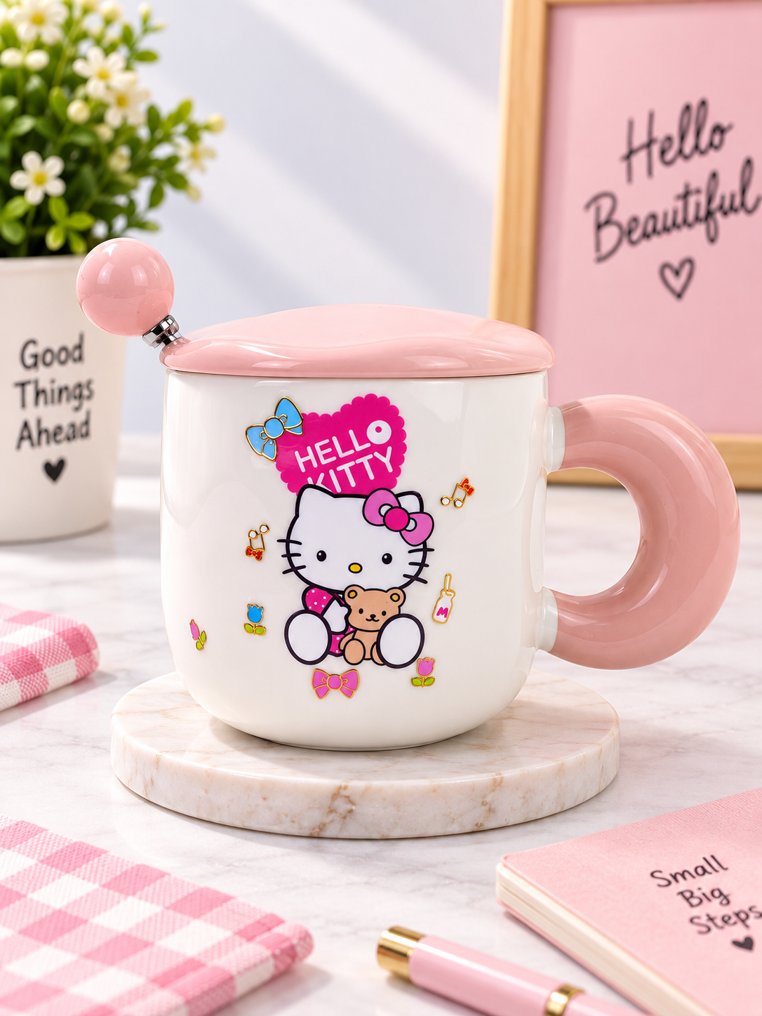 Ceramic coffee mug with lid and spoon, white with Hello Kitty print, pink lid and handle.