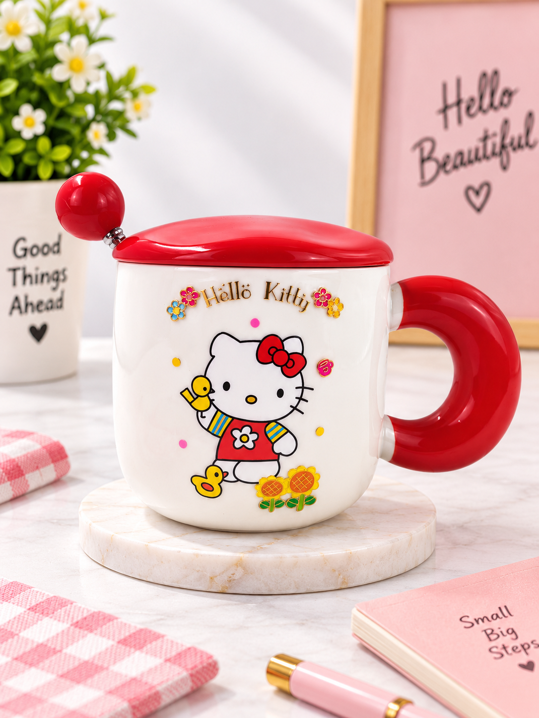 Ceramic coffee mug with lid and spoon, white with Hello Kitty print, red lid and handle.