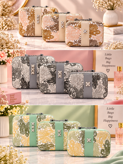 Three lace floral vanity cases in grey, green, and beige with jeweled clasps