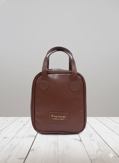 Brown leather-look makeup bag with top handle and front logo patch