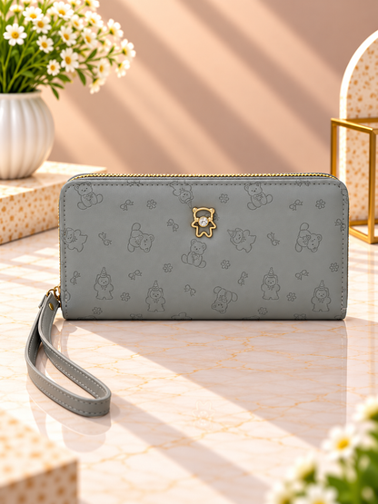 Gray zip-around wristlet wallet with debossed character pattern and wrist strap