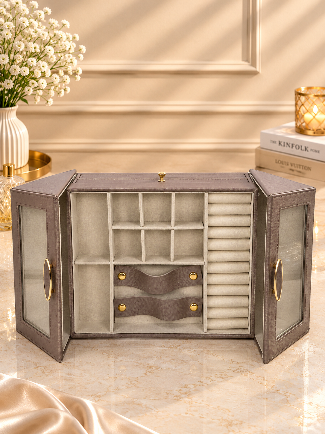 Taupe winged jewelry cabinet with glass doors open, showing ring and earring slots
