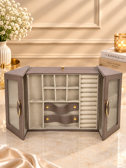 Taupe winged jewelry cabinet with glass doors open, showing ring and earring slots