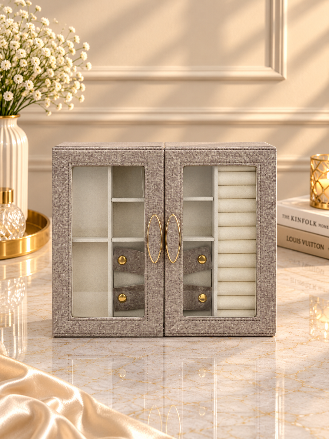 Taupe jewelry storage cabinet with glass doors and gold hardware accents