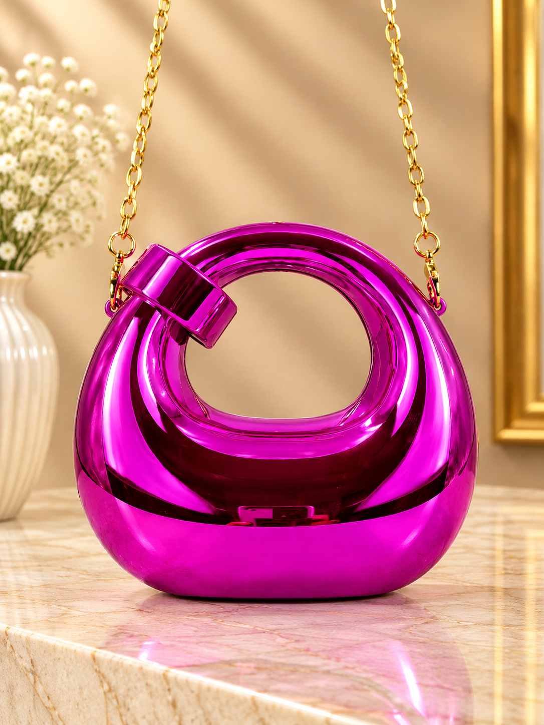 Pink metallic ring-loop evening handbag with chain strap and hinged handle
