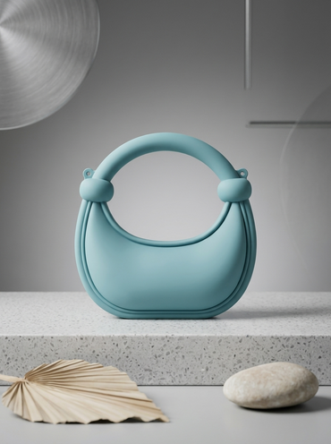 Light blue matte silicone crescent handbag with rounded ring handles
