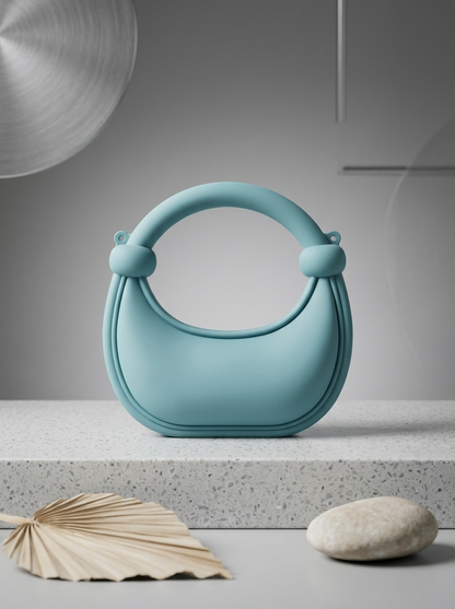 Light blue matte silicone crescent handbag with rounded ring handles
