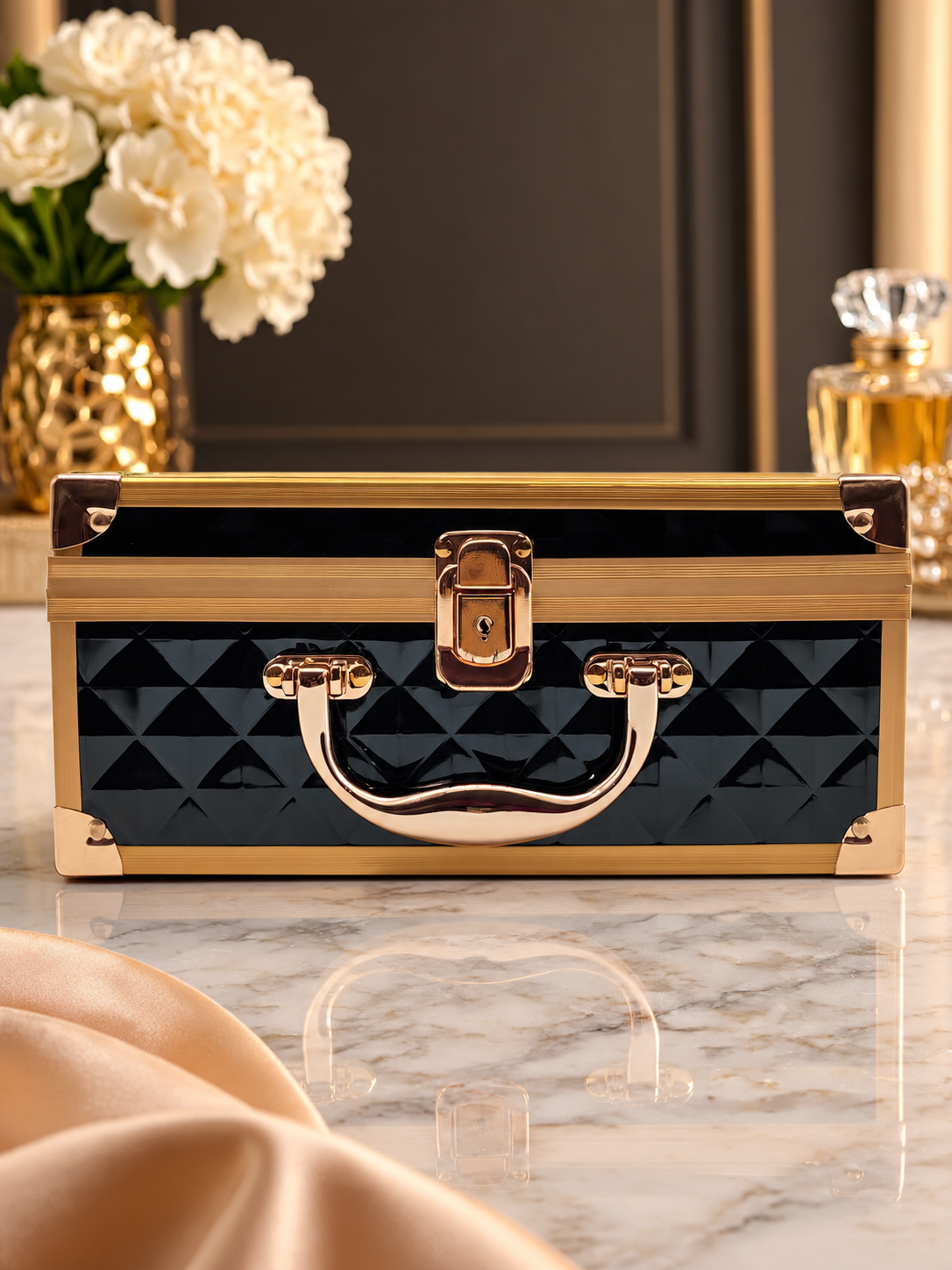 Closed diamond-quilted vanity box with rose gold handle and latch, glossy hard shell
