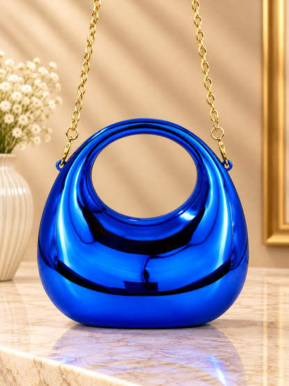 Blue metallic crescent evening handbag with glossy finish and gold chain straps