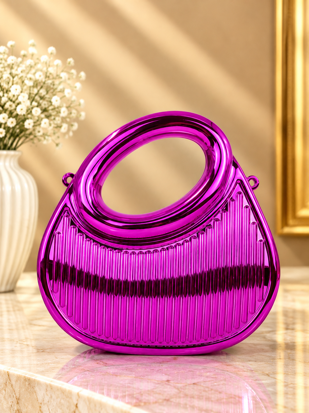 Pink pleated metallic evening handbag with oval top handle and purple-toned hardware