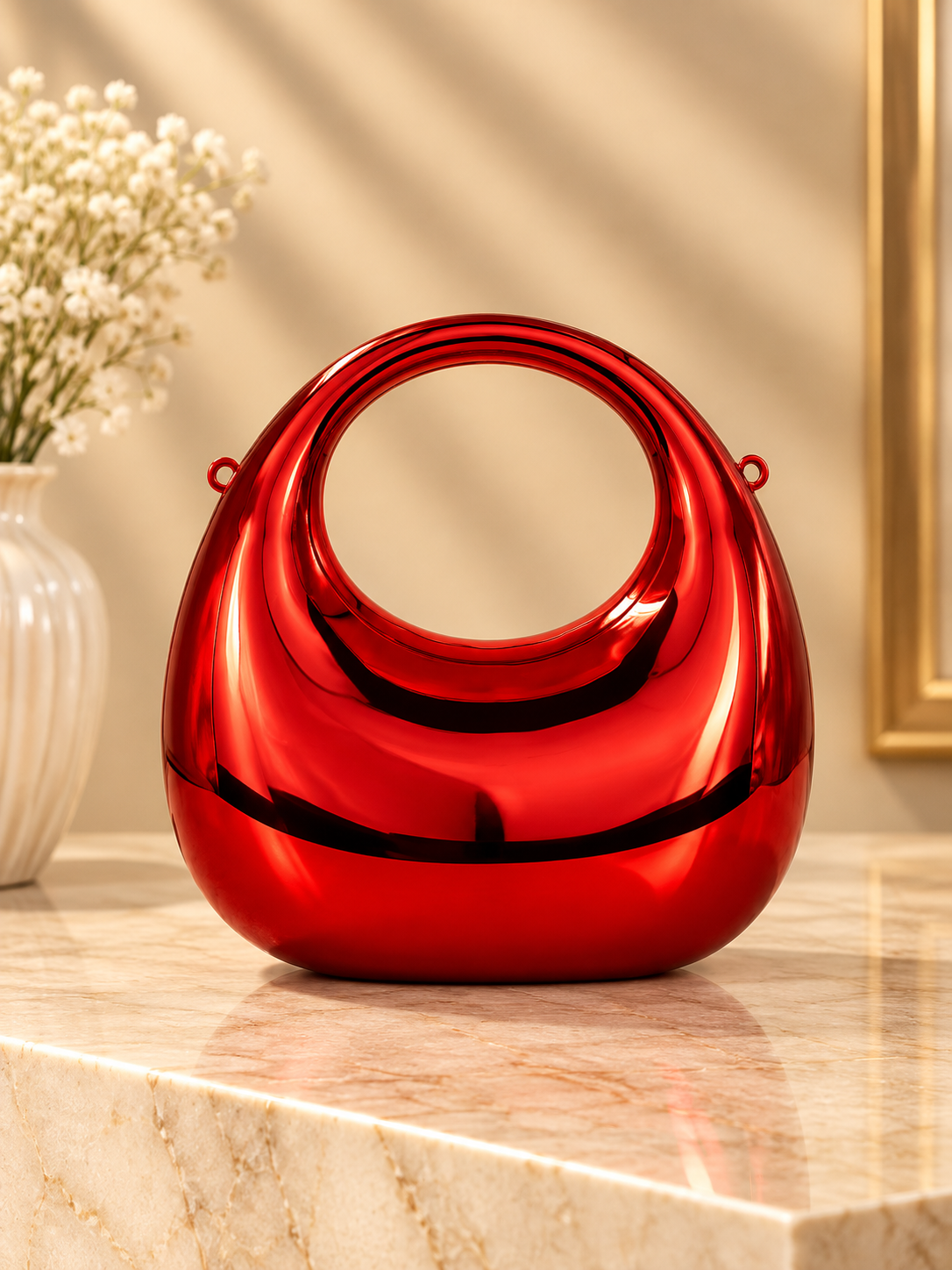 Red metallic crescent evening handbag with glossy finish, no chain visible