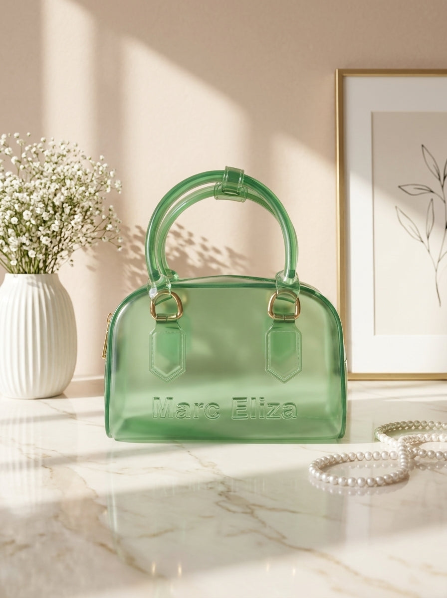Green jelly barrel handbag with top handles, zip closure, and Marc Eliza logo.