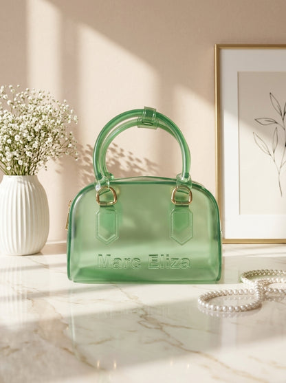 Green jelly barrel handbag with top handles, zip closure, and Marc Eliza logo.