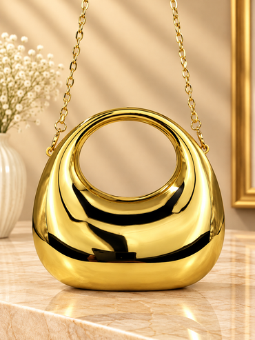 Gold metallic crescent evening handbag with glossy mirror finish and gold chain straps