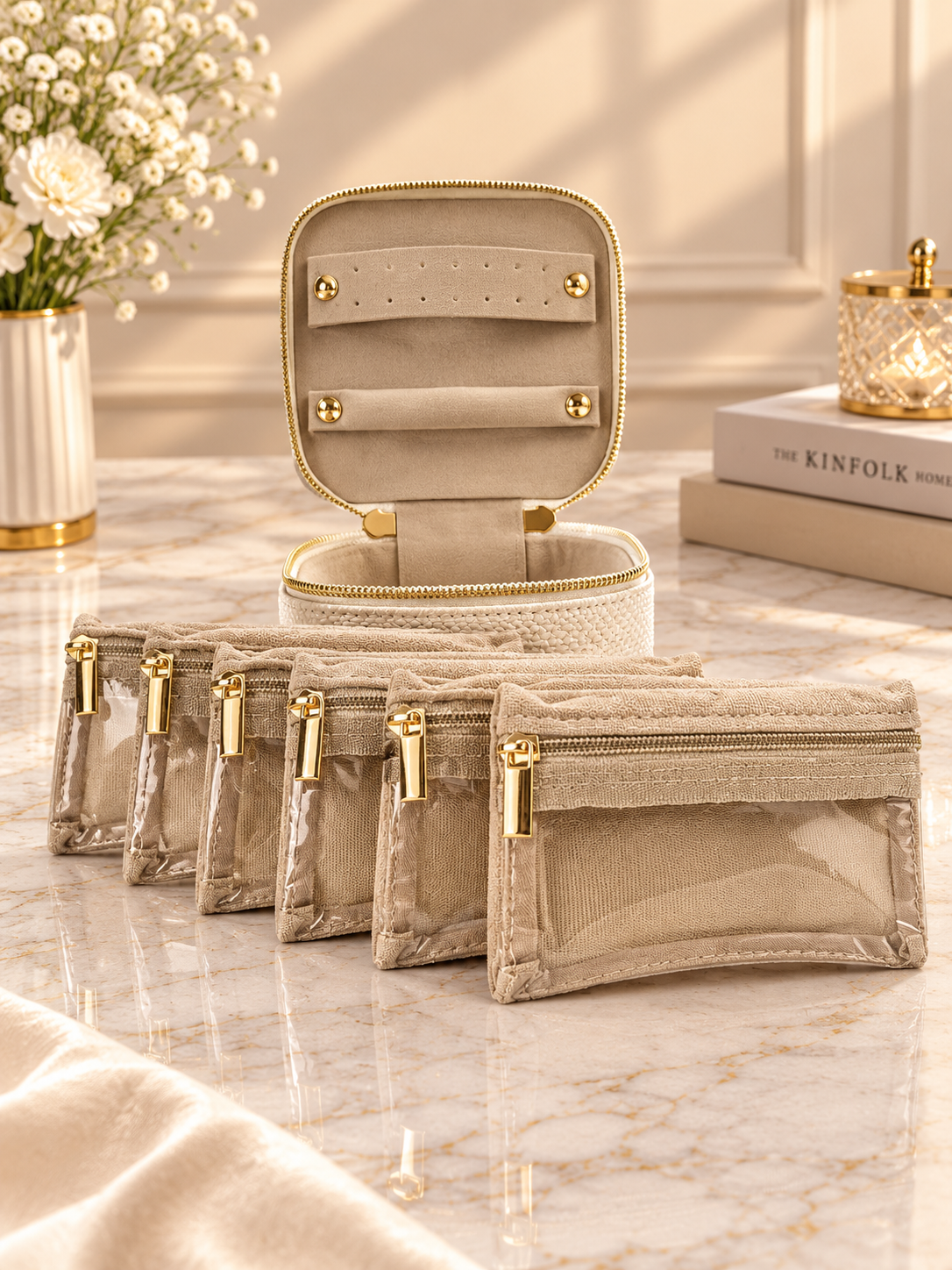Cream velvet jewelry organizer case with fold-out compartments and gold zipper pulls