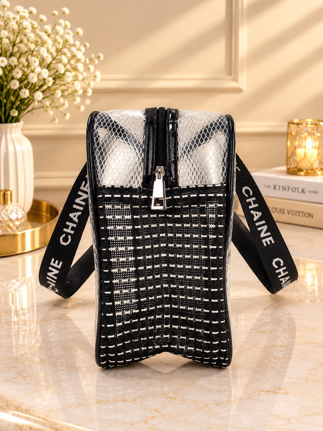 Black mesh travel toiletry bag open with clear compartments and central zipper