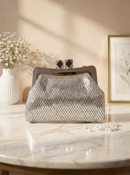 Silver crystal mesh frame clutch with geometric clasp and structured frame top