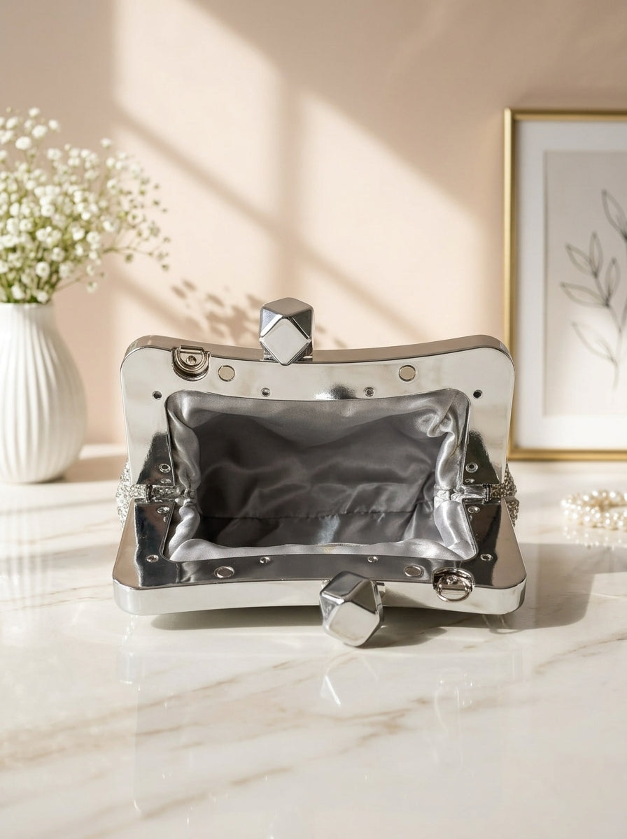 Silver crystal mesh frame clutch with geometric snap clasp, open interior lining