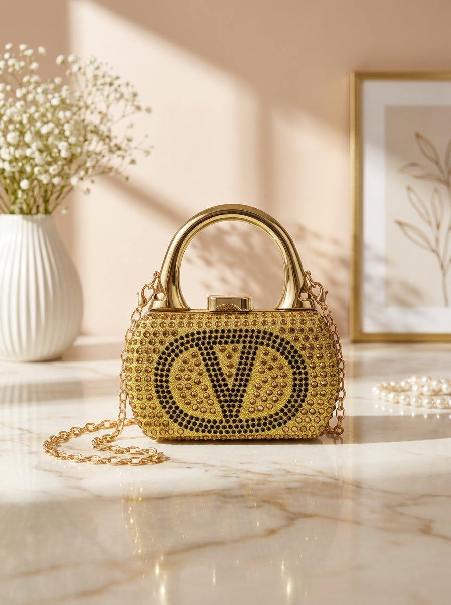 Gold crystal-encrusted mini minaudiere handbag with V monogram and chain strap