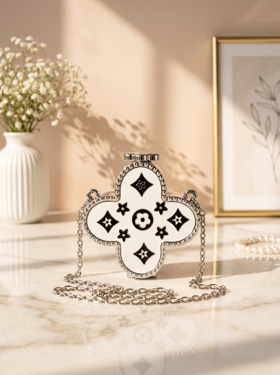 Silver four-leaf clover monogram evening clutch with black enamel and chain strap