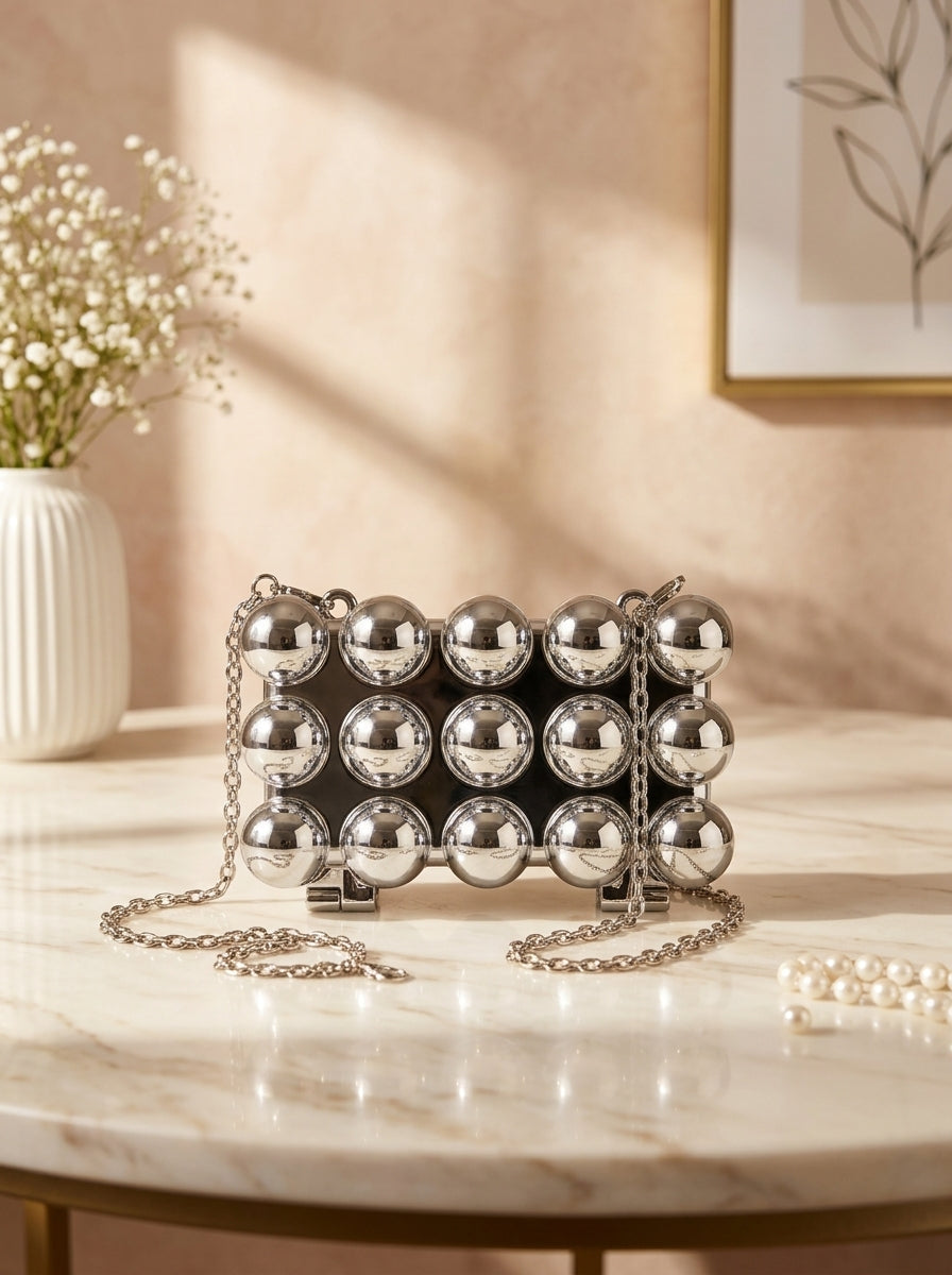 Silver bubble-studded spherical evening clutch with chain strap