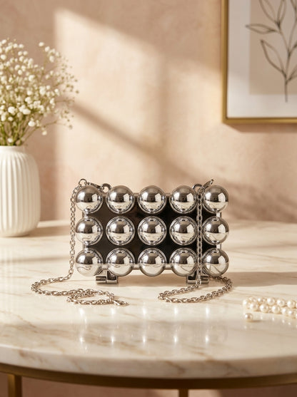 Silver bubble-studded spherical evening clutch with chain strap