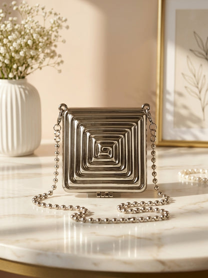 Silver geometric spiral clutch with hinged flap and beaded shoulder chain